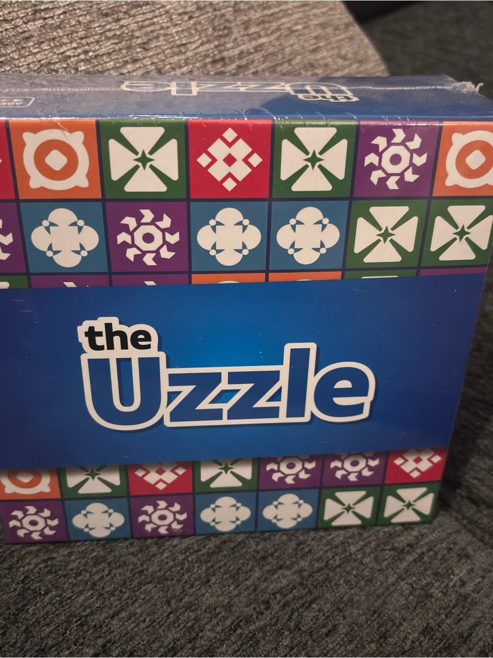 The Uzzle Blue Puzzle Game Box - Colorful Patterned Design